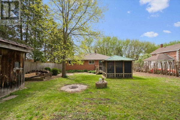 Backyard with screened gazebo, fire pit, and wood shed - 2063 George Street Howick