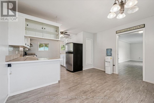 Kitchen with breakfast bar, stainless steel refrigerator, and water cooler - 2063 George Street Howick