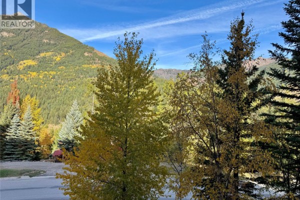 Close-up view of trees with autumn foliage and a mountain in the distance. - 2064 Summit Drive Unit# 106, Panorama