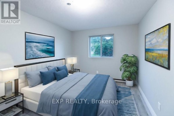 Bedroom with a king-size bed, bedside tables, and artwork. - 575 Lake Street, St  Catharines