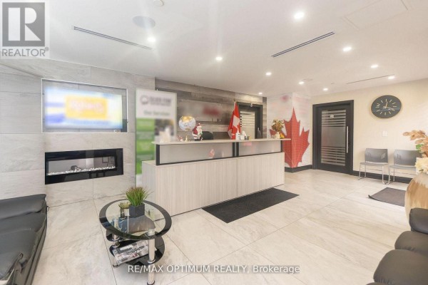Glass door with frosted stripes leading to office space. - 207 - 7895 Tranmere Drive, Mississauga