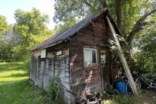 Old wooden shed with a metal roof, a small window, and a wooden door. - 207 Jane Street, Bonnechere Valley