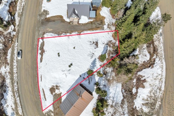 Aerial view of a snowy lot outlined in red, with houses and trees. - 20716 Sakwi Creek Road, Mission