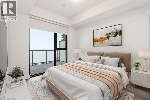 Close-up of the modern kitchen with light wood cabinetry, stainless steel appliances, and a balcony view. - 2075 Lakeshore Road Unit# 1106, Burlington