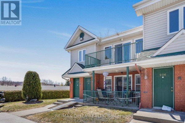 Exterior view of apartment buildings with brick and siding, green doors, and balconies. - 208 - 2927 Laurier Street, Clarence Rockland
