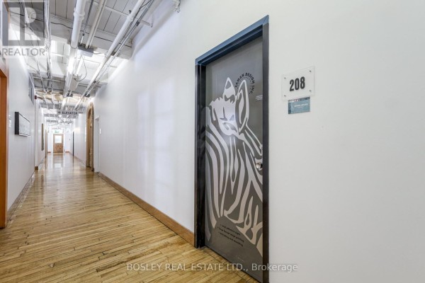 Hallway showing unit 208 with a zebra graphic on the door. - 208 - 401 Richmond Street W, Toronto