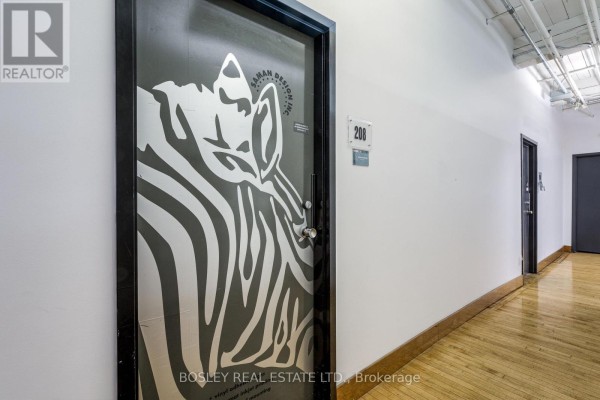 Close-up of unit 208 door with zebra graphic and hallway view. - 208 - 401 Richmond Street W, Toronto