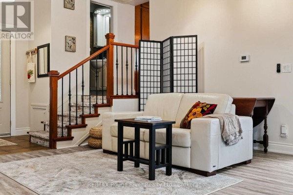 White leather sofa, folding screen, and wood staircase - 208 Albert Street Cobourg