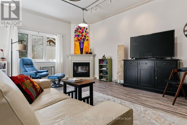 Living room with fireplace and TV - 208 Albert Street Cobourg