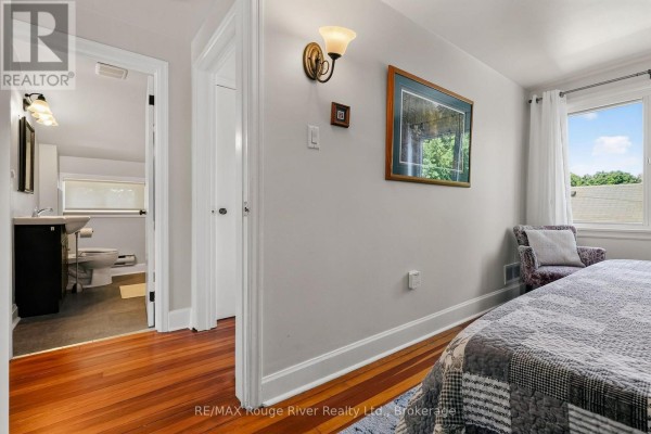 Bedroom with hardwood floors and adjacent bathroom - 208 Albert Street Cobourg