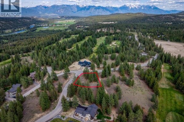 Aerial view of a lot with a red marker, bordered by roads and overlooking a golf course. - 208 Corral Boulevard Lot# 30, Cranbrook