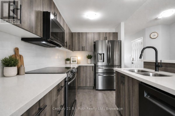 Modern kitchen with grey wood-grain cabinets, white quartz countertops, stainless steel appliances, and a black faucet. - 208 Diana Drive, Orillia