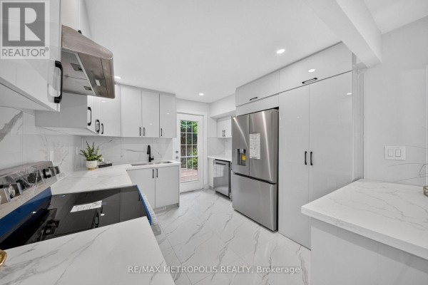 Detailed view of the house with snow, trees, and yard features. - 208 Palmerston Avenue, Whitby