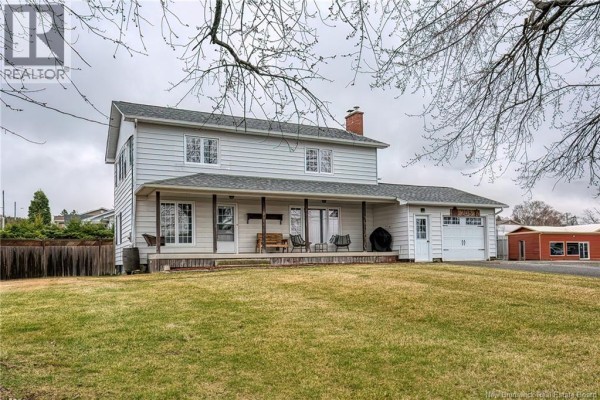 Exterior view of the house with a large front lawn and covered porch. - 208 St Georges Road, Grand Falls