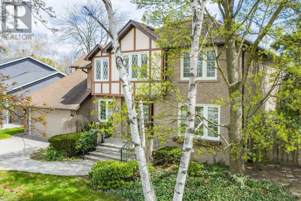 Front view of the house at 2082 Mississauga Road with a stone pathway. - 2082 Mississauga Road, Mississauga