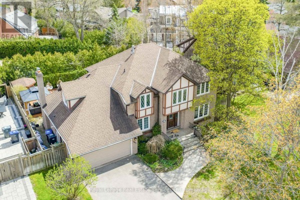 Aerial view showing the backyard of the house with a patio and hot tub. - 2082 Mississauga Road, Mississauga