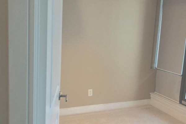 Empty room with beige carpeted floor, light beige walls, and white trim, blinds cover the window. - 209 - 18 Yorkville Avenue, Toronto