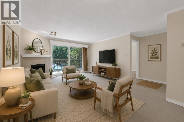 Living room with beige carpet, fireplace, and large sliding glass doors. - 209 10220 Ryan Road, Richmond