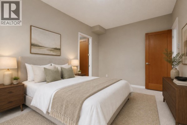 Bedroom with a king-size bed, nightstands, dresser, and an ensuite doorway. - 209 240 Salter Street, New Westminster