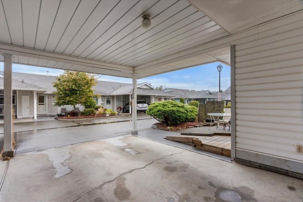 View from covered carport looking towards the duplex entrance and outdoor seating area. - 209 7610 Evans Road, Sardis West Vedder, Chilliwack