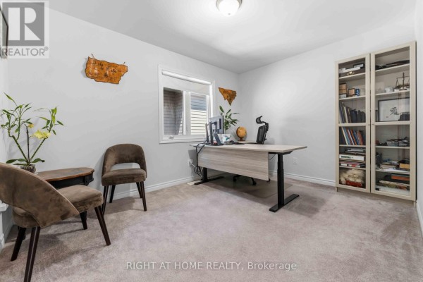 Modern home office with standing desk and bookshelf - 209 Quarter Horse Street Ottawa