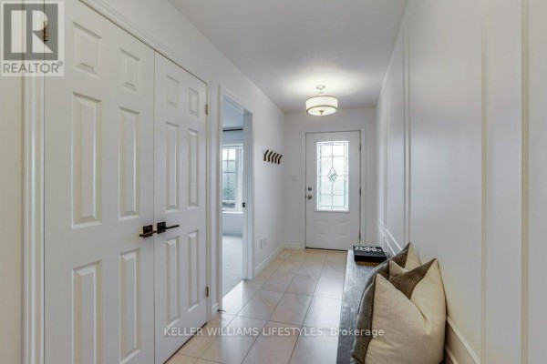 Interior entryway with cream colored walls, a closet, and a glass-paneled front door. - 2090 Denview Avenue, London North