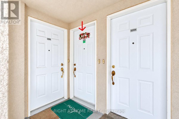 Close-up view of three townhouse entrances with white doors and numbered plaques. - 2095 - 55 George Appleton Way, Toronto