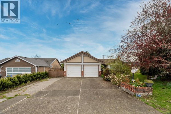 View of a modern building complex with extensive parking and road network under a cloudy sky. - 2095 Jahn Pl, Sidney