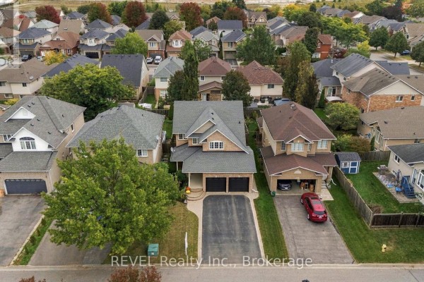 Aerial view of residential street showing 2097 Stornoway Street with surrounding homes and trees. - 2097 Stornoway Street, Oshawa