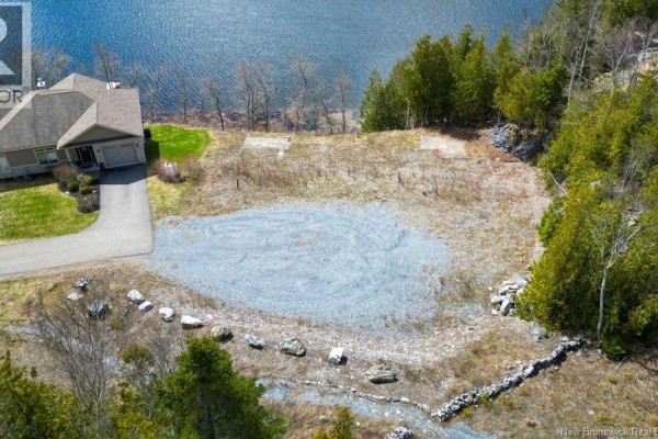 Overhead view of a cleared building lot with a gravel base, showing driveway and waterfront access. - 21-2 Upper Deck Lane, Saint John