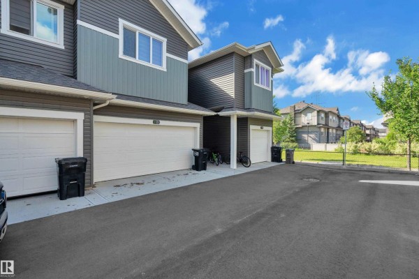 View of a green park with pathways and houses. - #21 603 Orchards Bv Sw, Edmonton