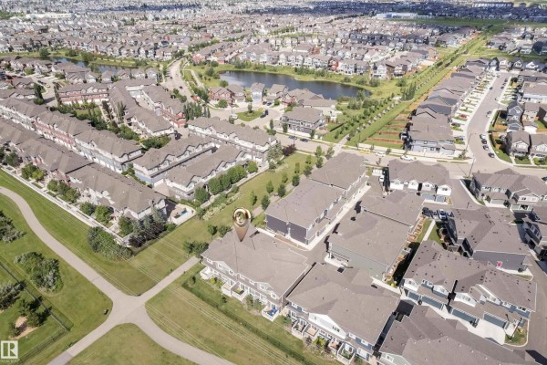 View of a green park with pathways and houses. - #21 603 Orchards Bv Sw, Edmonton