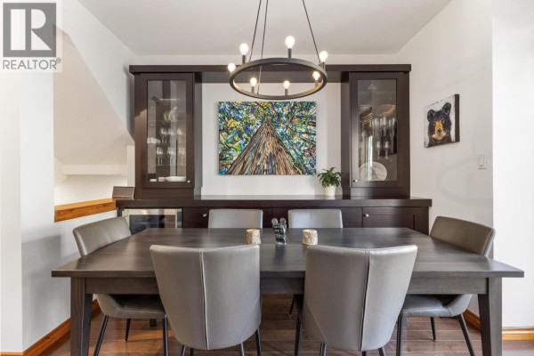 Formal dining room with a dark wood table, chairs, and a built-in buffet. - 21 8030 Nicklaus North Boulevard, Whistler