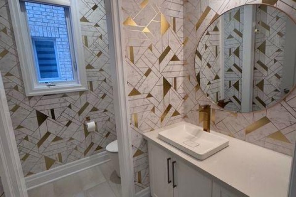 Powder room with a geometric gold and white tiled wall, and a window. - 21 Casavant Court, Vaughan