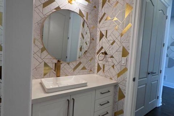 Powder room vanity with a white rectangular sink, gold faucet, and round mirror. - 21 Casavant Court, Vaughan