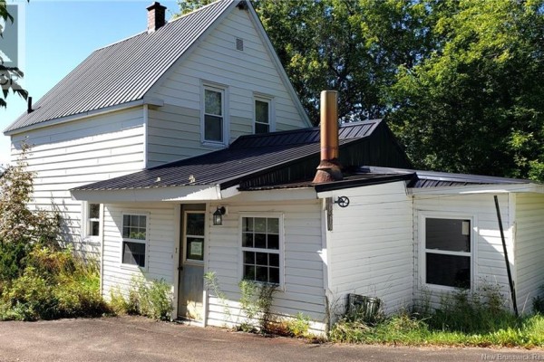 Rear view of the white house showing an attached extension with a copper chimney pipe. - 21 Clifford Street, Mcadam