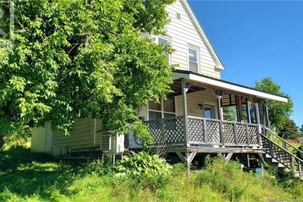 Side view of the house and covered porch with lattice railings and stairs. - 21 Clifford Street, Mcadam