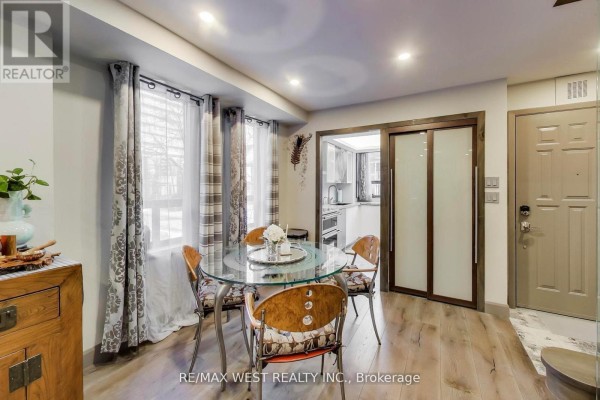 Living room featuring a stone fireplace, large windows, and modern furniture - 21 Dundonald Street, Toronto
