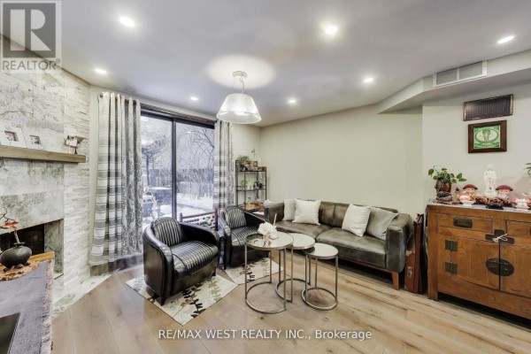 Dining area with glass table, chairs, and view into kitchen - 21 Dundonald Street, Toronto