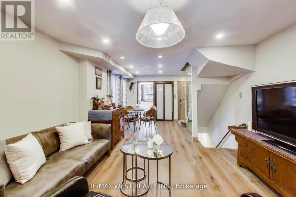 Kitchen with modern cabinetry, stainless steel appliances, and granite countertops - 21 Dundonald Street, Toronto