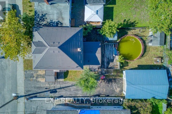 Overhead view of a house with a dark roof, a backyard, and a pool. - 21 Garrison Street, Ottawa