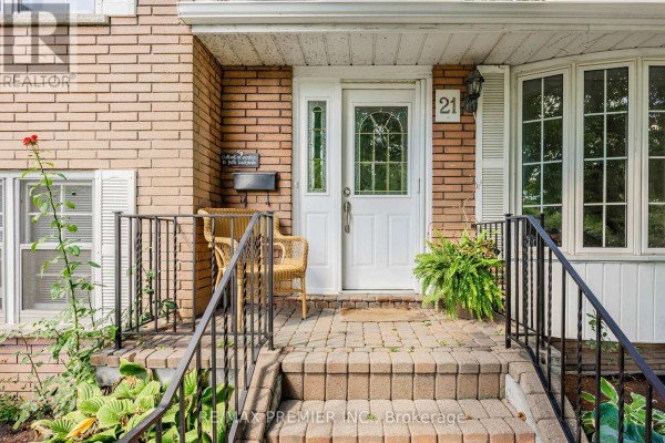Walk-in shower with glass doors, chrome fixtures, and grab bars, featuring tiled walls. - 21 Halbadier Place, Toronto