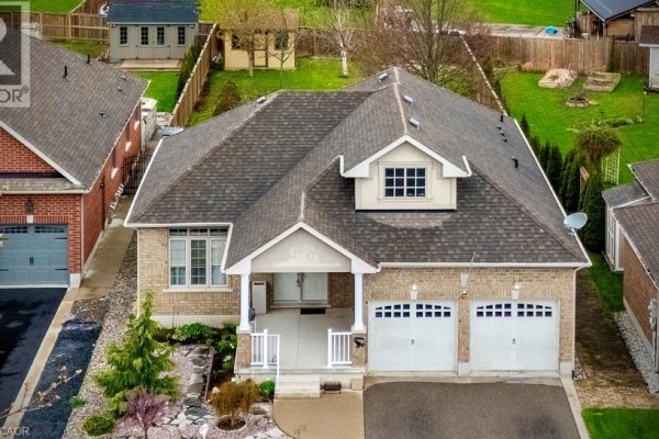 Aerial view of a residential street with multiple houses, a large RV parked in a driveway. - 21 Kelly Drive, Port Dover