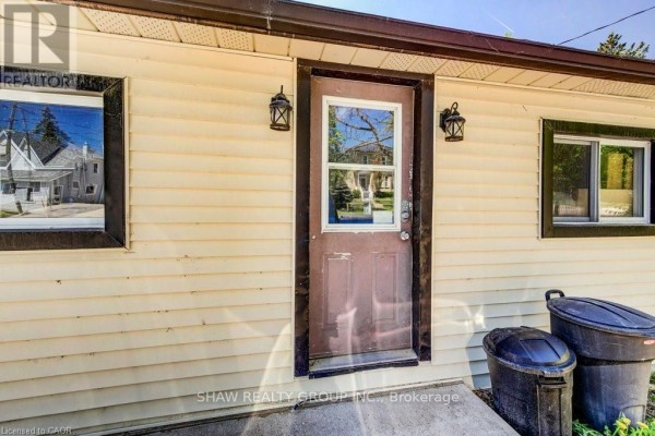 Small bedroom with sloped ceiling, single bed, and built-in storage, featuring a Spider-Man blanket. - 21 Main Street W, Mapleton