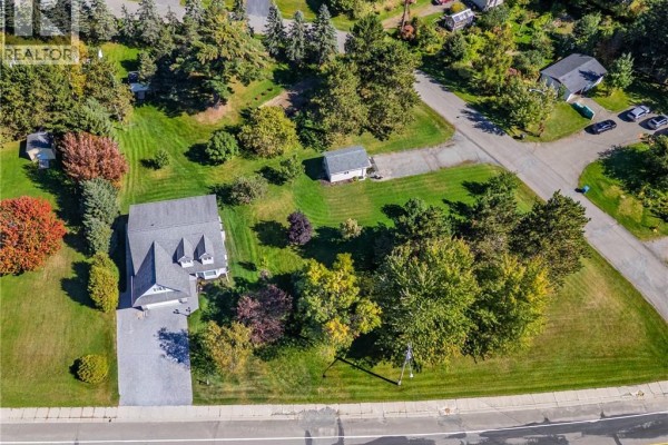 Aerial view of a residential property at 21 Principale Street, Riviere Verte, with a house and surrounding grounds. - 21 Principale Street, Riviere Verte
