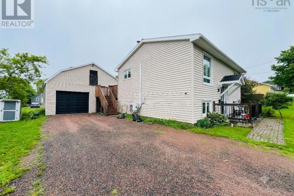 View of the gravel driveway, detached garage, and the right side of the house. - 21 Snowden Avenue, Amherst