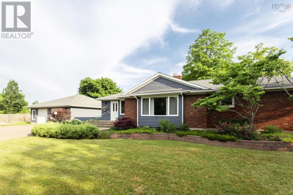 Front entrance of a brick and blue siding house with a large bay window and concrete steps. - 21 Spring Garden Road, Middleton