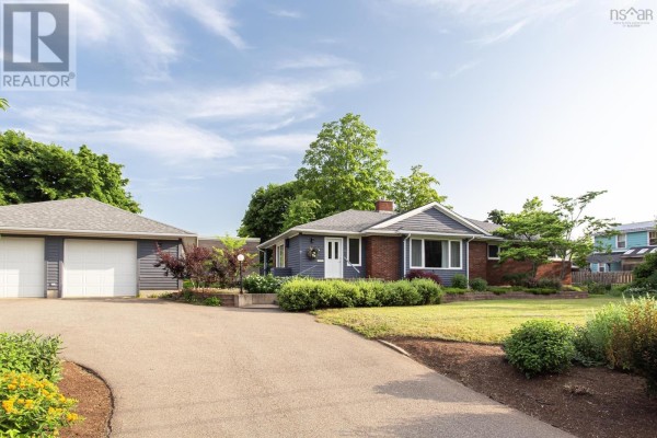 Two-bay detached garage with blue siding and white garage doors on an asphalt driveway. - 21 Spring Garden Road, Middleton