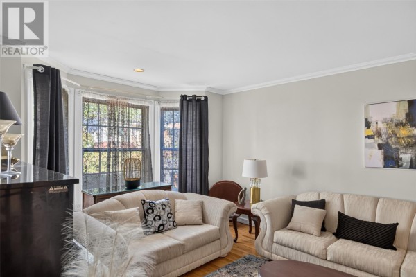 Living room with light grey walls, bay window, two sofas, and artwork. - 21 Symonds Place, St  John’s