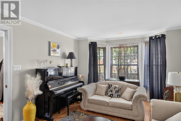 Living room with a piano, two sofas, bay window, and dark grey curtains. - 21 Symonds Place, St  John’s